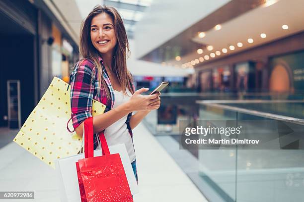 femme profitant de la journée dans le centre commercial - shop photos et images de collection