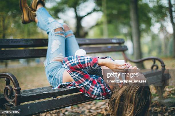young woman talking over phone - coffee cup upside down stock pictures, royalty-free photos & images