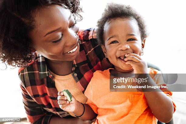 mother and daughter portrait - baby eating food stock pictures, royalty-free photos & images
