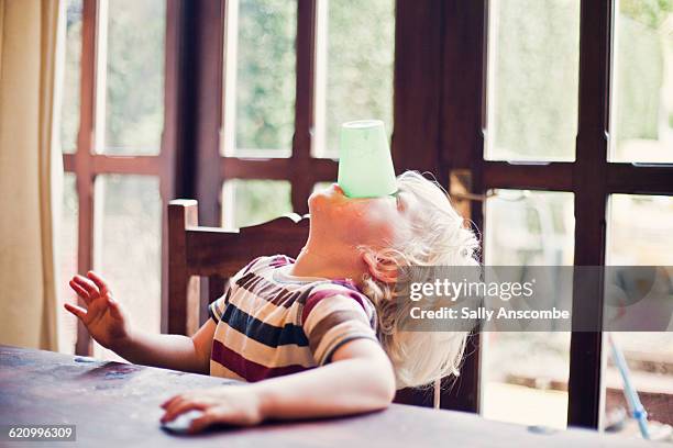 child drinking a cup of milk - food and drink stockfoto's en -beelden