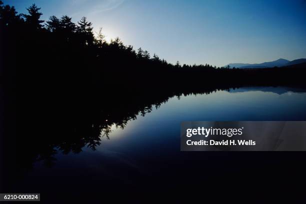 calm lake in evening - lighting technique stock illustrations