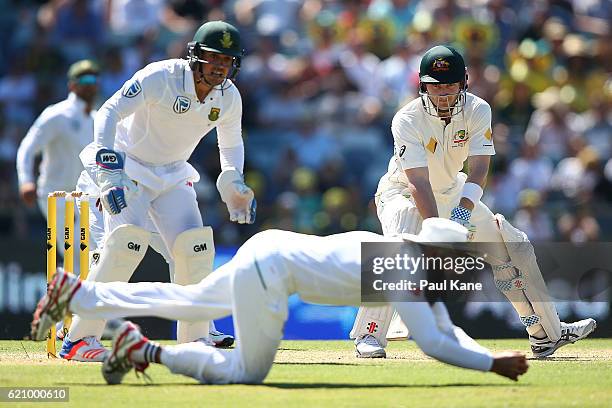 Peter Nevill of Australia looks on as Hashim Amla of South Africa takes a catch during day two of the First Test match between Australia and South...