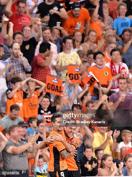 Jamie Maclaren of the Roar celebrates with Tommy Oar after scoring a goal during the round five A-League match between the Brisbane Roar and...