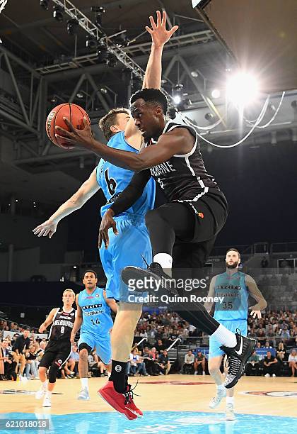 Cedric Jackson of United passes behind the back of Kirk Penny of the Breakers during the round five NBL match between Melbourne United and the New...
