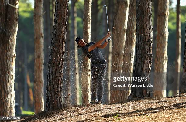 Tommy Fleetwood of England plays his second shot out of the trees on the 12th hole during the second round of the Turkish Airlines Open at the Regnum...