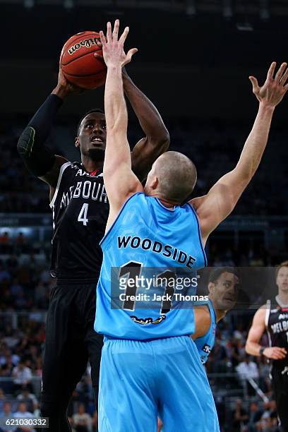 Cedric Jackson of Melbourne United shoots the ball over Ben Woodside of the Breakers during the round five NBL match between Melbourne United and the...