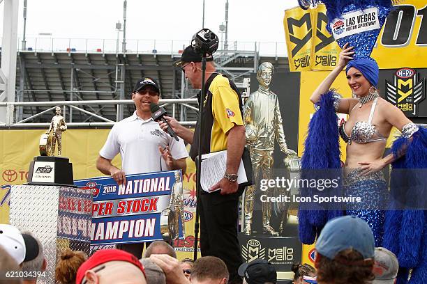 Jimmy DeFrank is presented the Super Stock Champion trophy prior to the NHRA Toyota Nationals on October 30 at The Strip at Las Vegas Motor Speedway...