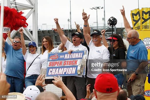 Jimmy DeFrank and his family and crew celebrate winning the Super Stock Championship prior to the NHRA Toyota Nationals on October 30 at The Strip at...