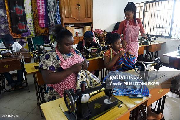 Women sew clothes at Idia Renaissance non-governmental organisation in Benin-city, Edo State, midwest Nigeria, on October 21, 2016. In 2015 000...