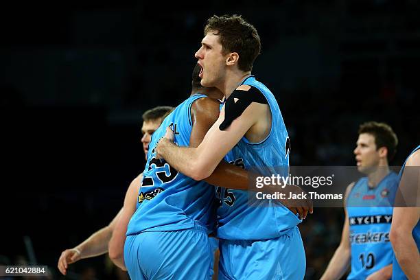 Robert Loe of the Breakers celebrates hitting a three pointer with team mate Akil Mitchell of the Breakers during the round five NBL match between...