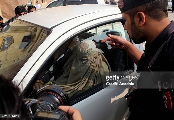 Police escort Afghan refugee woman Sharbat Gula , before a court hearing in Peshawar, Pakistan on November 04, 2016. The Afghan woman whose teenage...