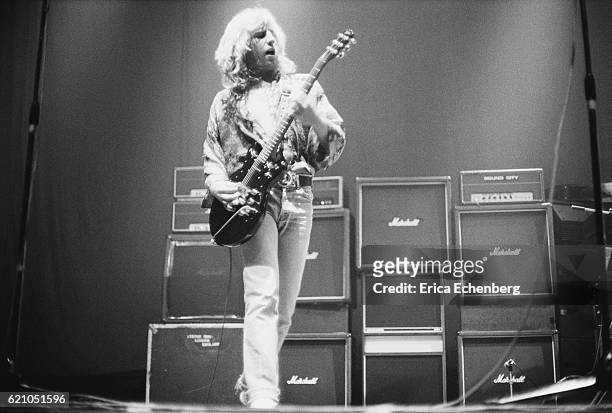 Rick Parfitt of Status Quo performs on stage in front of a stack of Marshall amplifiers, Bingley Hall, Stafford, January 9th 1977.