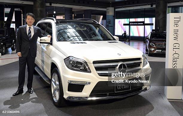 Japan - Mercedes-Benz Japan Co. President Kintaro Ueno stands beside a fully remodeled GL-class sport utility vehicle in Osaka on April 22, 2013. The...