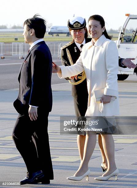 Netherlands - Japanese Crown Prince Naruhito and Crown Princess Masako walk across the airport tarmac upon arriving in Amsterdam on April 28 to...