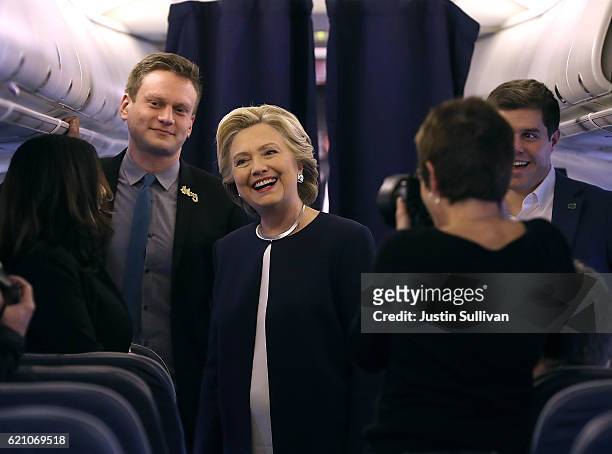 Democratic presidential nominee former Secretary of State Hillary Clinton talks with members of her staff aboard her campaign plane at Westchester...