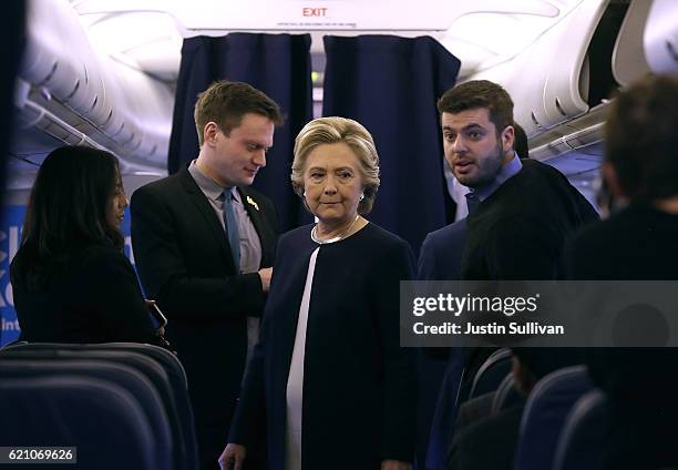 Democratic presidential nominee former Secretary of State Hillary Clinton talks with members of her staff aboard her campaign plane at Westchester...