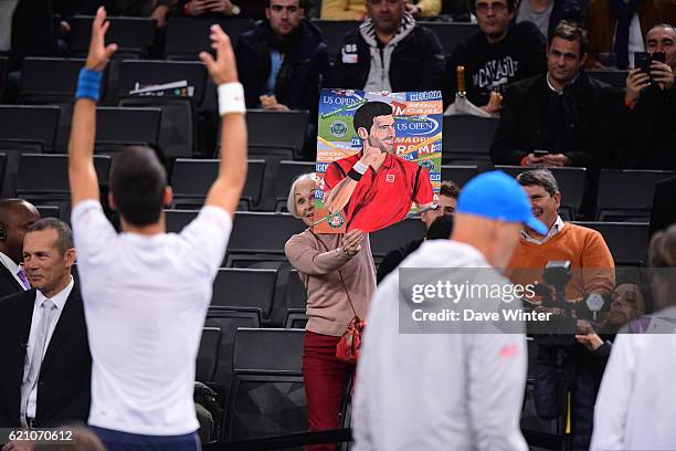 Novak Djokovic of Serbia and one of his fans during the Mens Singles quarter final match on day five of the BNP Paribas Masters at Hotel Accor Arena...