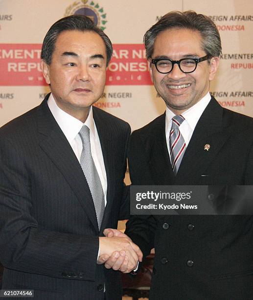 Indonesia - Chinese Foreign Minister Wang Yi and Indonesian Foreign Minister Marty Natalegawa shake hands prior to their talks in Jakarta on May 2,...