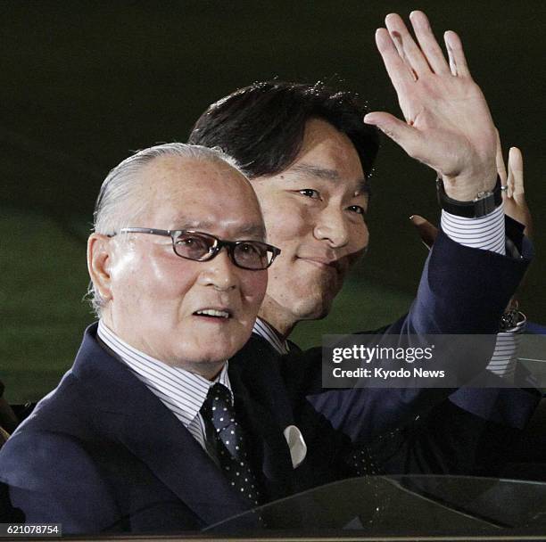 Japan - Former professional baseball players Hideki Matsui and Shigeo Nagashima, Matsui's first pro skipper, wave at fans aboard a car making a...