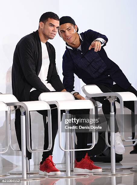 Cristiano Ronaldo and Pepe of Real Madrid chat during a promotional event by the German carmaker Audi at Carlos Sainz Center on November 4, 2016 in...