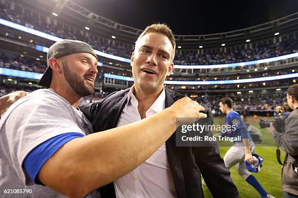 President of Baseball Operations Theo Epstein of the Chicago Cubs celebrates on the field with his team after defeating the Cleveland Indians in Game...