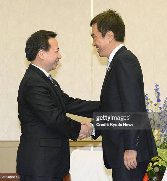 Japan - China's vice minister for environmental protection Li Ganjie and Japanese Environment Minister Nobuteru Ishihara shake hands prior to their...