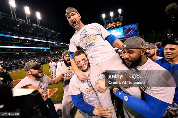 World Series: Chicago Cubs David Ross victorious, being carried by Antony Rizzo and Jason Heyward after winning game and series vs Cleveland Indians...