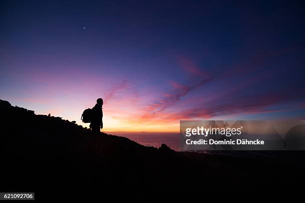 a photographer with colourful sky (la palma island. canaries. spain) - la palma canarische eilanden stockfoto's en -beelden