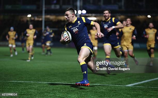 Josh Adams of Worcester breaks with the ball to score the first try during the Anglo-Welsh Cup match between Worcester Warriors and Bristol at...