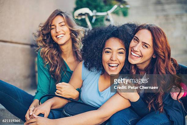 multi-ethnic group of girls laughing - girlfriend stock pictures, royalty-free photos & images