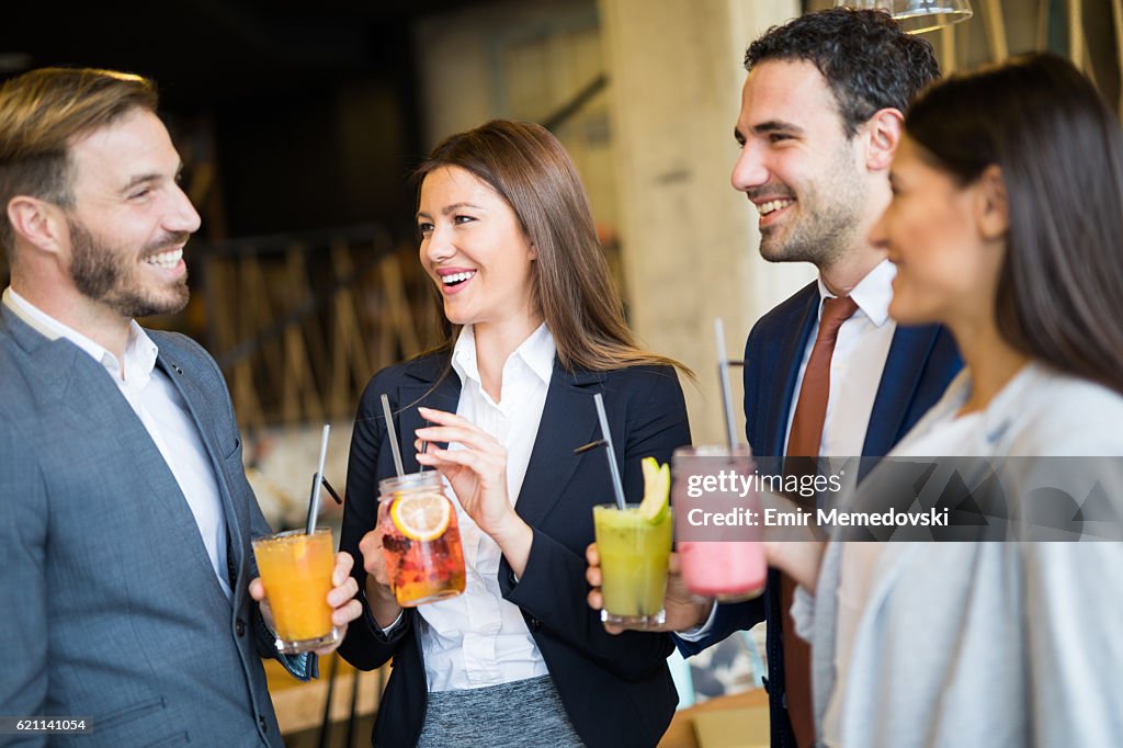 Business team taking a break and drinking healthy smoothies