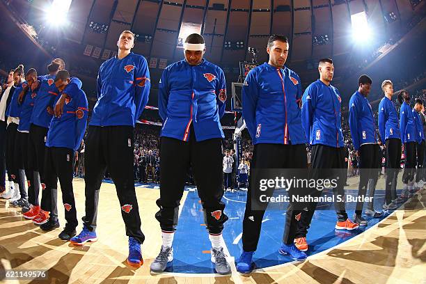 Kristaps Porzingis and Carmelo Anthony of the New York Knicks stand on the court for the National Anthem before the game against the Memphis...