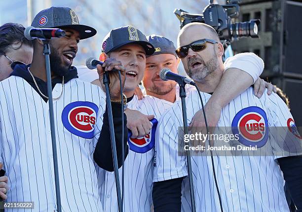 Dexter Fowler, Anthony Rizzo, Jon Lester and David Ross of the Chicago Cubs sing "Go, Cubs, Go" during the Chicago Cubs victory celebration in Grant...