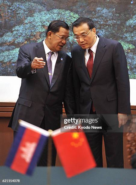 China - File photo shows Cambodian Prime Minister Hun Sen and Chinese Premier Li Keqiang chatting during a ceremony to sign documents at the Great...