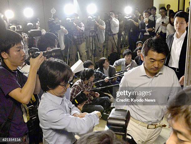 Japan - Osaka Mayor Toru Hashimoto departs after answering reporters' questions at the Osaka city offices on May 17 amid controversy over his series...