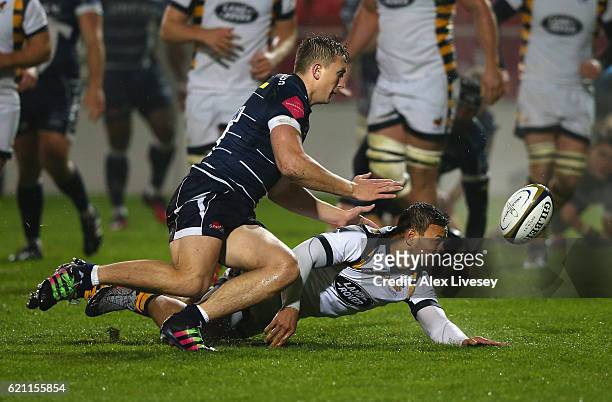 Sam Bedlow of Sale Sharks beats Alapati Leiua of Wasps to a loose ball to score a try during the Anglo-Welsh Cup match between Sale Sharks and Wasps...