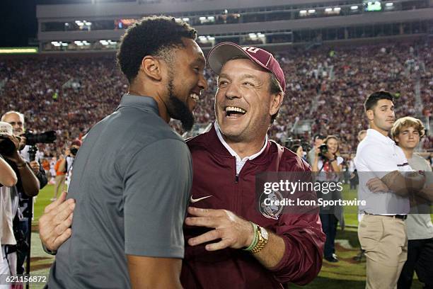 Florida State head coach Jimbo Fisher hugs former wide receiver Rashad Greene before an NCAA football game between the Florida State Seminoles and...