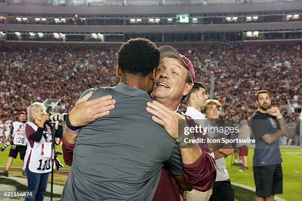 Florida State head coach Jimbo Fisher hugs former wide receiver Rashad Greene before an NCAA football game between the Florida State Seminoles and...