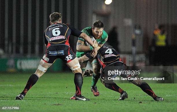 Connacht's Jake Heenan is tackled by Dragons' Nick Crosswell and Lewis Evans during the Guinness PRO12 Round 8 match between Newport Gwent Dragons...