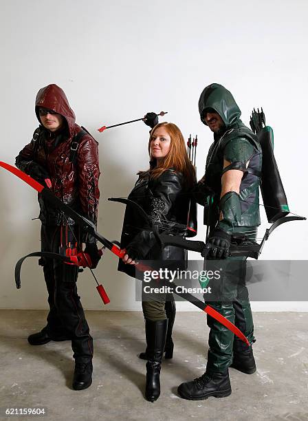 Cosplayers dressed with costumes of Arsenal, Cupid and green Arrow inspired by the seie TV "Arrow" pose during the Paris Manga & Sci-Fi Show at Parc...