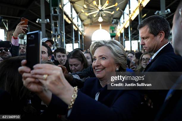 Democratic presidential nominee former Secretary of State Hillary Clinton takes a selfie with supporters during a campaign rally at Eastern Market on...