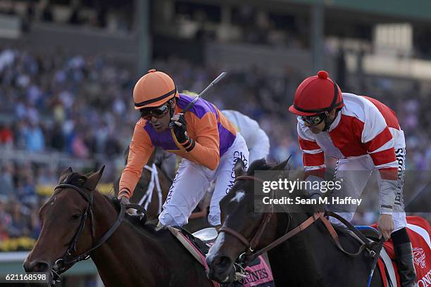 Jockey Gary Stevens riding Beholder speaks to jockey Mike Smith riding Songbird after the Longines Breeders' Cup Distaff during day one of the 2016...