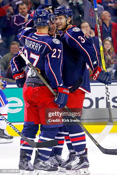 Josh Anderson is congratulated by Ryan Murray and William Karlsson, all of the Columbus Blue Jackets after scoring a goal during the second period of...