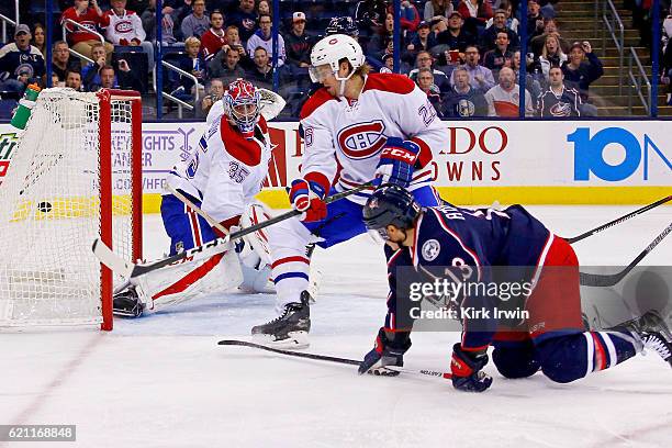 Cam Atkinson of the Columbus Blue Jackets beats Jeff Petry of the Montreal Canadiens and Al Montoya of the Montreal Canadiens for a goal during the...