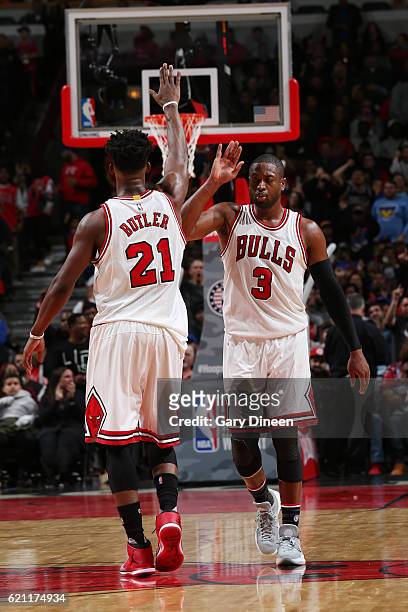 Jimmy Butler and Dwyane Wade of the Chicago Bulls high-five during a game against the New York Knicks on November 4, 2016 at the United Center in...