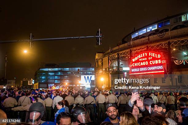 State police control the crowd as Chicago Cubs fans celebrate outside Wrigley Field after the Cubs defeated the Cleveland Indians in game seven of...