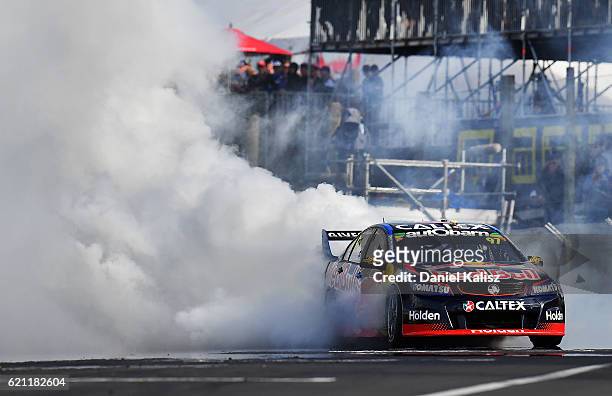 Shane Van Gisbergen drives the Red Bull Racing Australia Holden Commodore VF celebrates with a victory burnout after winning race 2 for the Supercars...