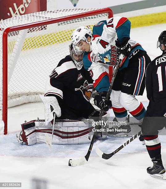 Goaltender Ryan Kubic of the Vancouver Giants makes a save against Nick Merkley of the Kelowna Rockets during the third period of their WHL game at...