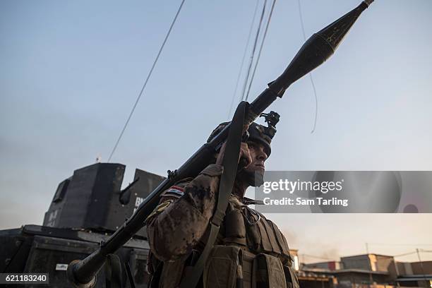 Sergeant Majid holds a rocket propelled grenade as Iraqi Special Forces advance through the neighborhood of Tahrir and Zahara, formerly named after...