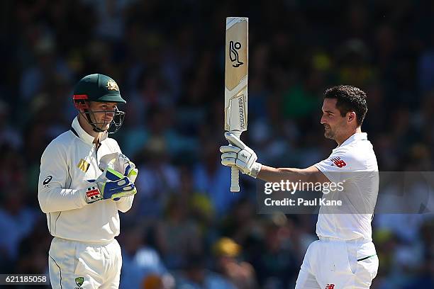 Dean Elgar of South Africa celebrates his century as Peter Nevill of Australia looks on during day three of the First Test match between Australia...